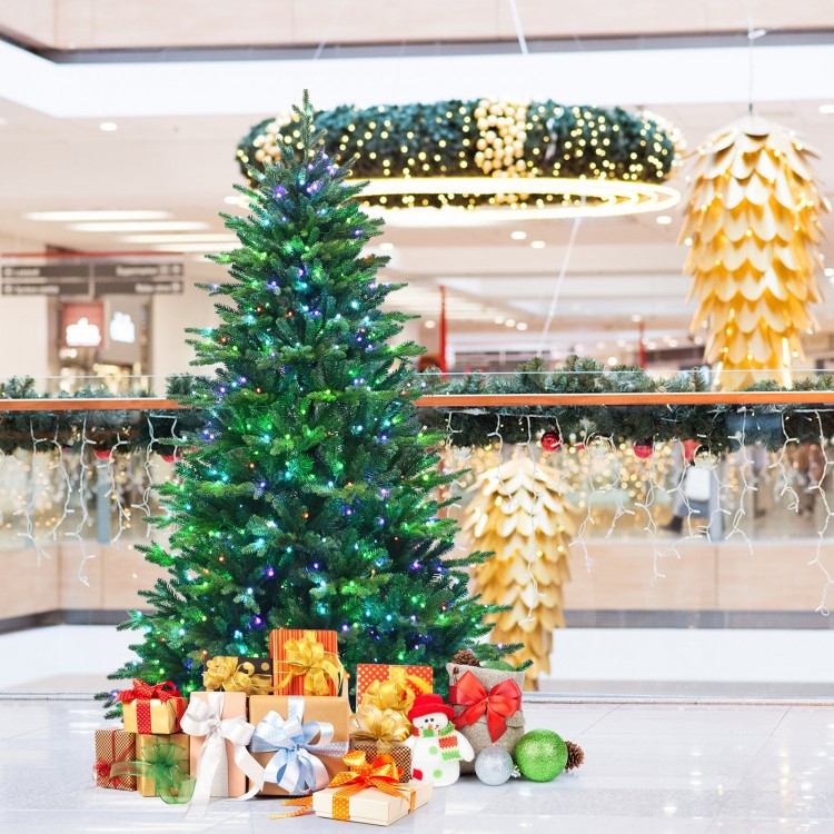 Pre-lit 7' artificial Christmas tree with colorful LED lights and presents, perfect for festive holiday decor.