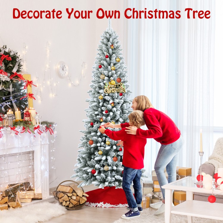Snow-flocked 7.5' artificial Christmas pencil tree with a decorative red base, perfect for creating a festive.