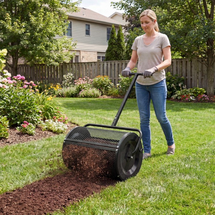 Compost spreader with height-adjustable T-handle, efficiently spreading peat moss in a garden setting.