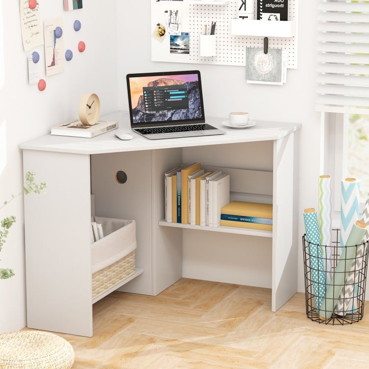 Corner computer desk with white finish, triangle design, storage shelf, and cable management for efficient workspace.