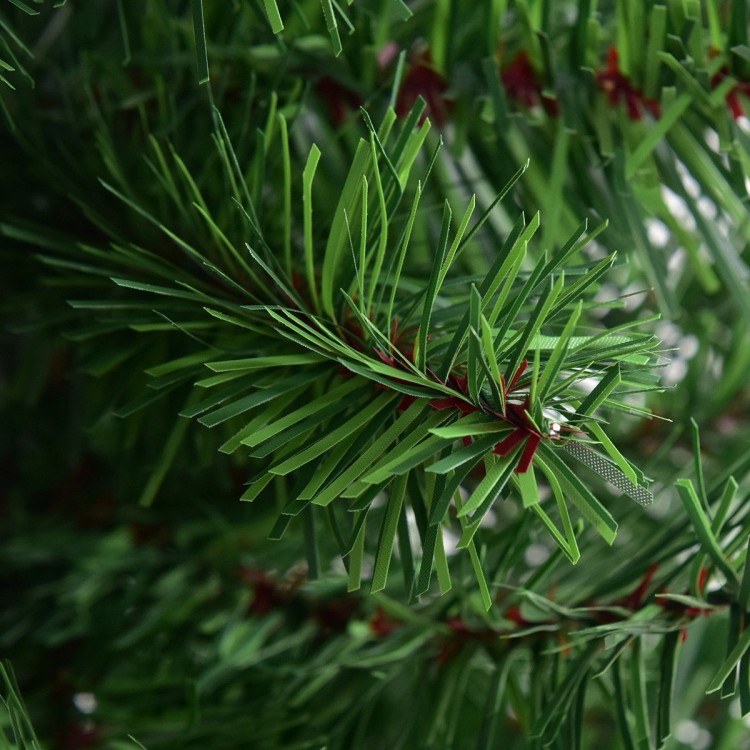 Close-up of the realistic green branches of a 2 ft artificial PVC Christmas tree, perfect for holiday decorating.