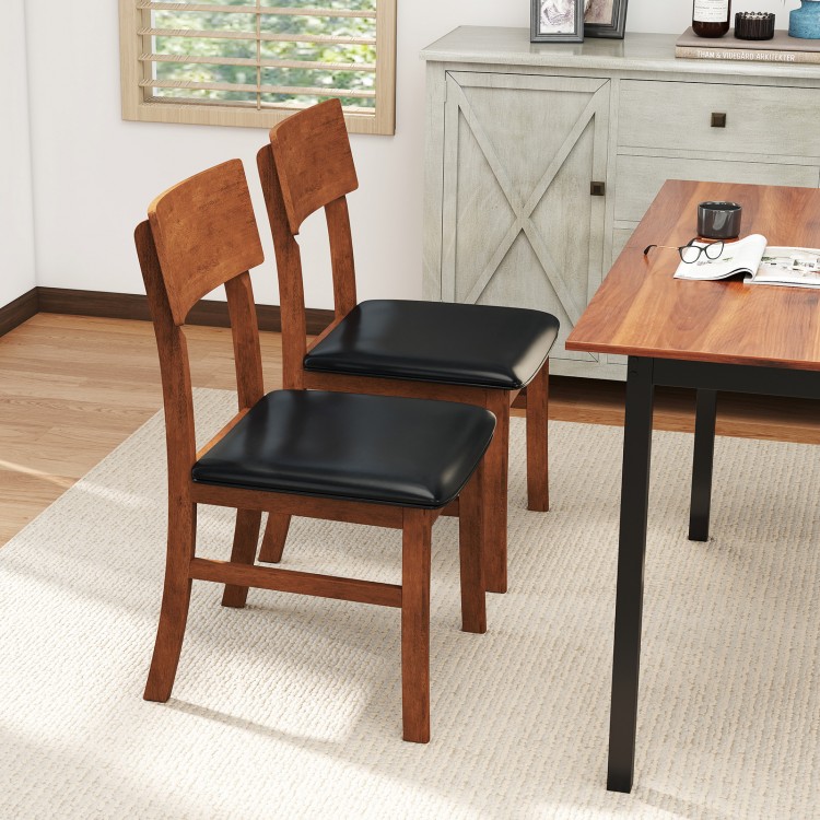 Set of 2 dining chairs with rubber wood legs and black faux leather seats, perfect for kitchen or dining room use.
