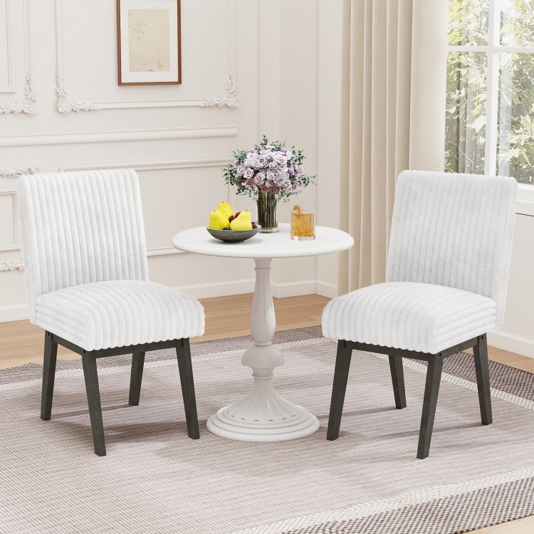 Set of 2 white fabric upholstered dining chairs with padded seats and rubber wood legs, ideal for kitchen or dining.
