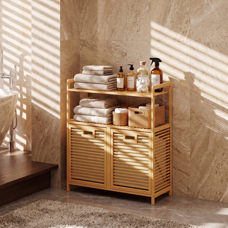 Natural bamboo double tilt-out laundry hamper with two shelves for easy sorting and storage in bathrooms or laundry rooms.