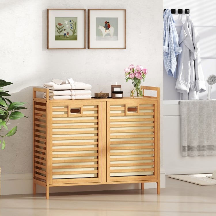 Double tilt-out laundry hamper in natural bamboo with two removable bins, ideal for sorting clothes in any room.