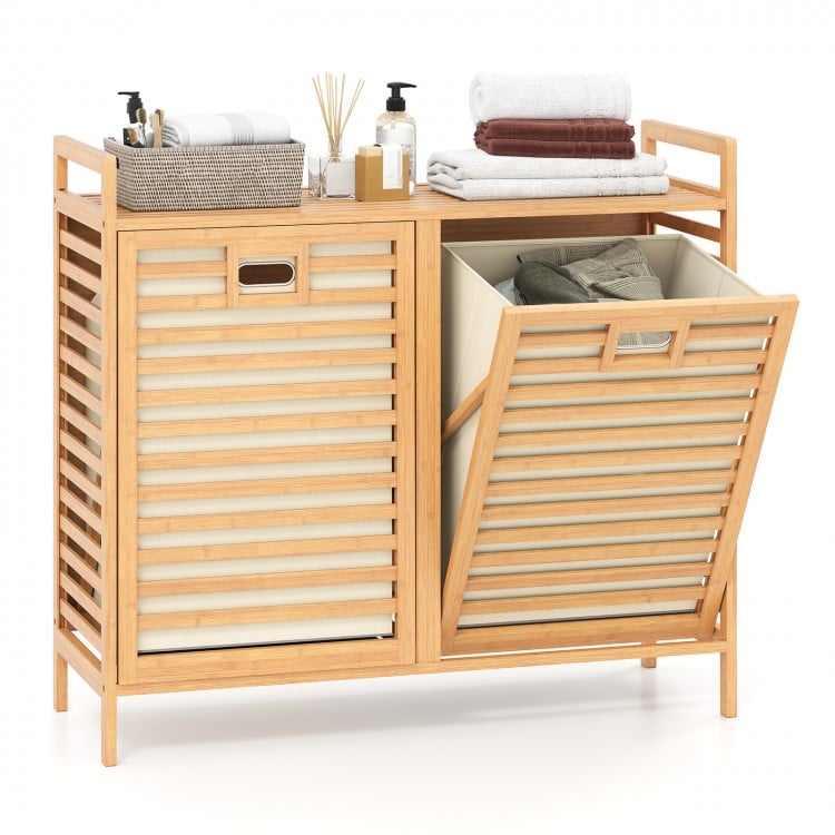 Double tilt-out laundry hamper with natural bamboo finish, featuring two removable bins and a top storage shelf for.