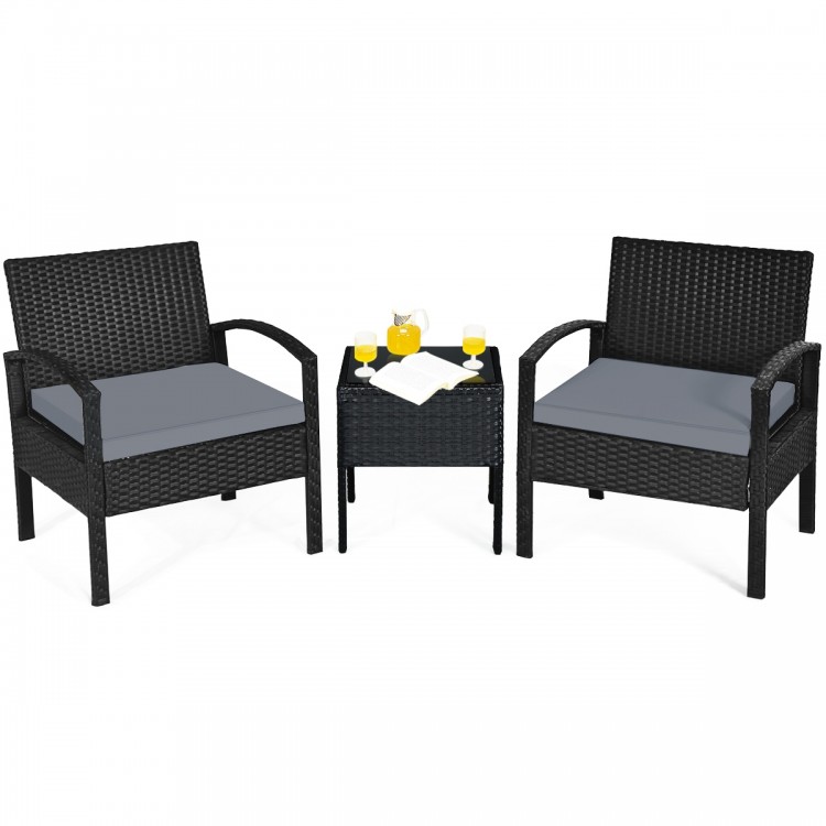 Three-piece outdoor rattan patio conversation set with gray cushions and a tempered glass table, perfect for backyard.