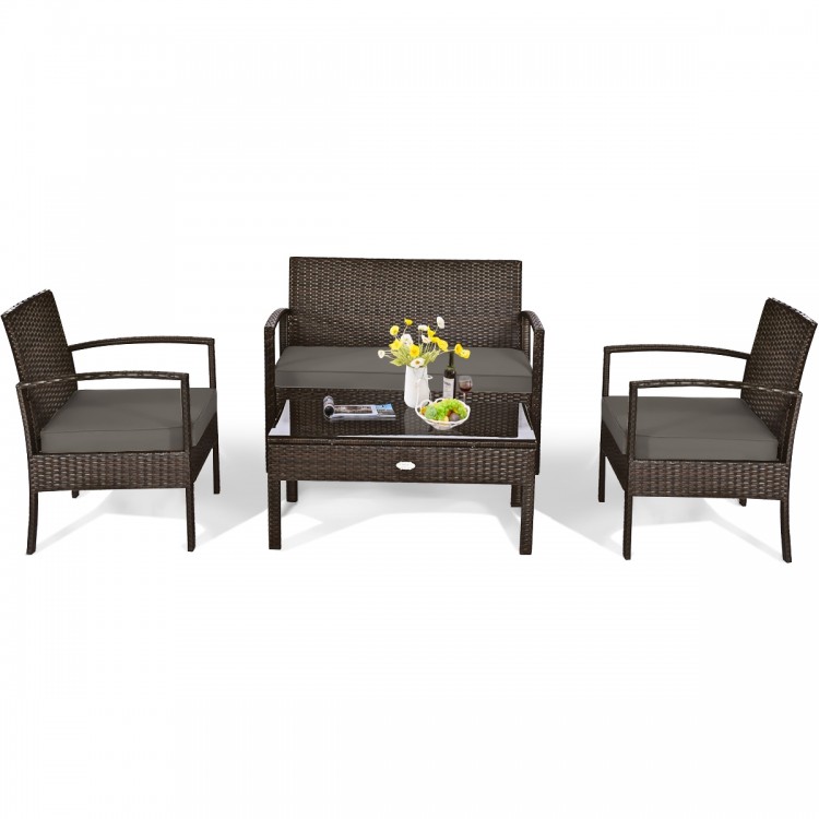Patio rattan furniture set featuring a loveseat, two chairs, and a coffee table with soft cushions for outdoor.
