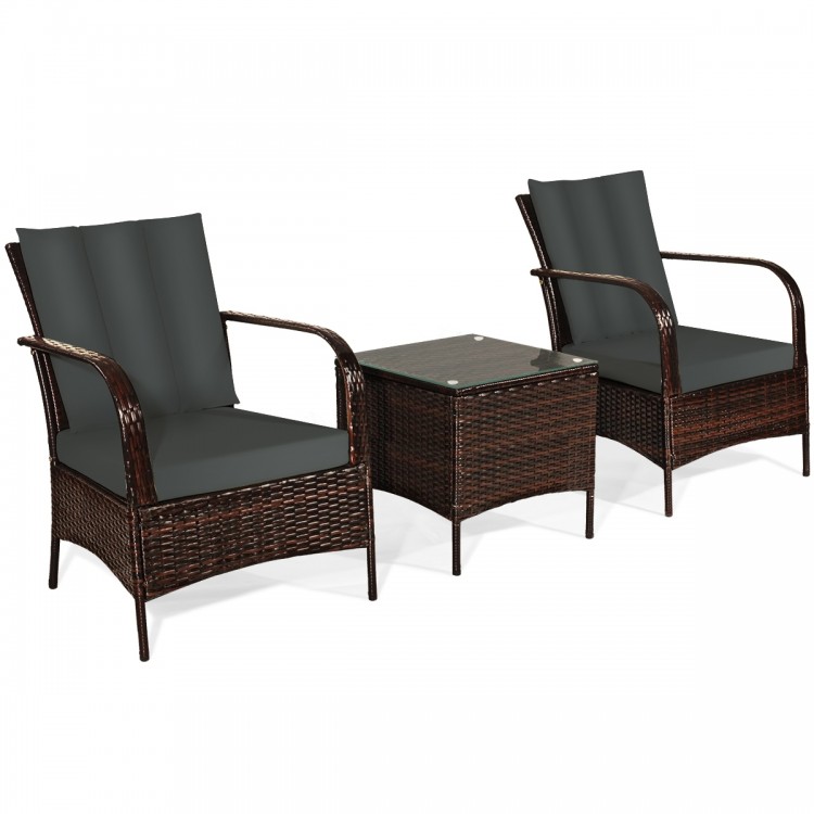 Two gray cushioned rattan chairs and a coffee table with tempered glass, perfect for outdoor patio relaxation.
