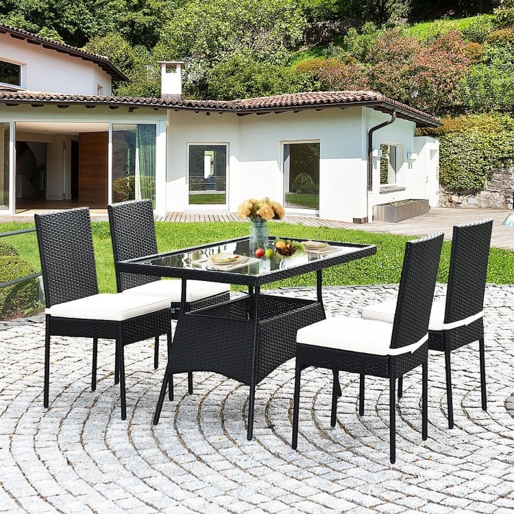 5-piece outdoor patio rattan dining set with glass top and cushions, featuring a sturdy steel frame and.