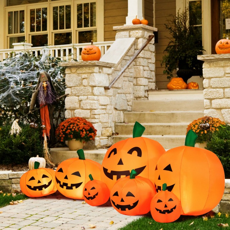 Colorful inflatable Halloween pumpkin patch with LED lights, featuring seven cheerful pumpkins for festive outdoor.