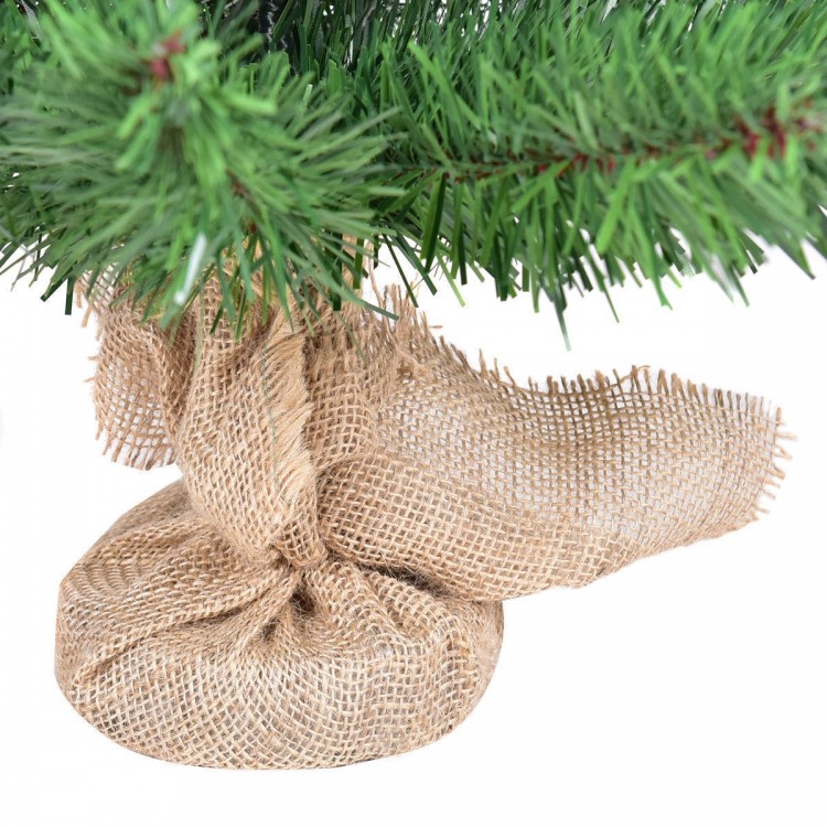Burlap bag base of a 2 ft artificial PVC Christmas tree, providing stability for festive holiday decor.