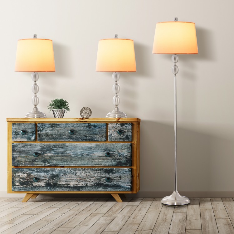 Three-piece table and floor lamp set with modern design, featuring durable metal construction and soft illumination.