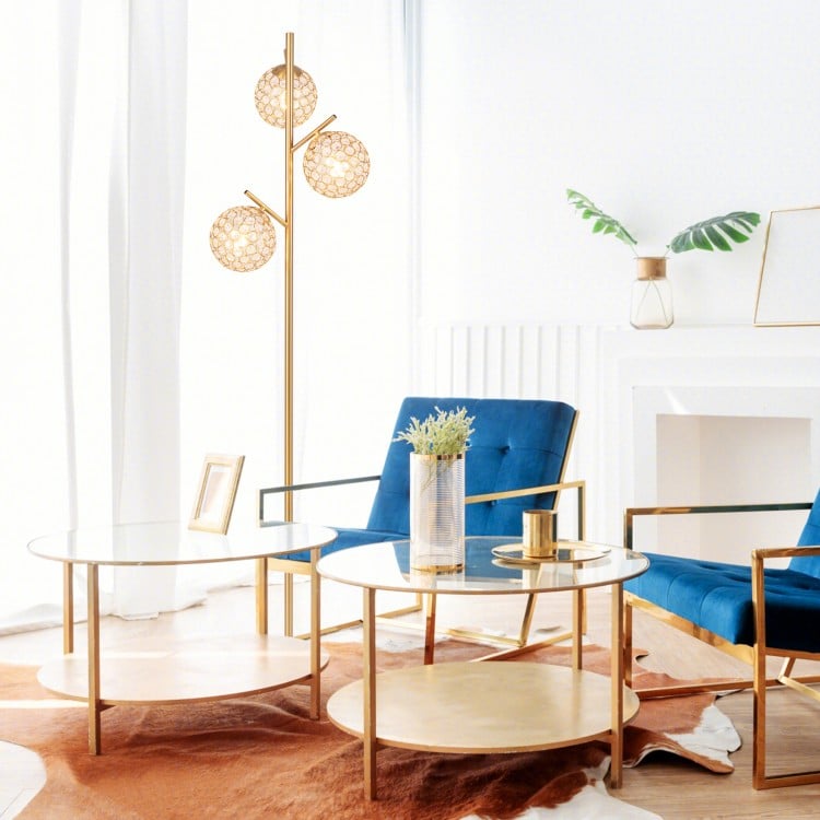 Golden 3-globe floor lamp with acrylic shades and foot switch, showcasing a stylish design for modern home decor.