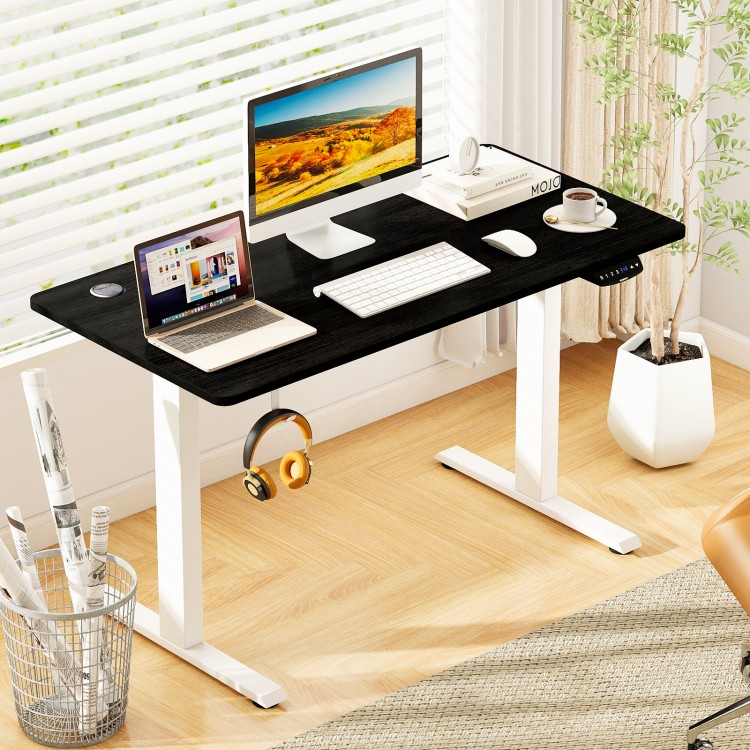 Electric standing desk in black with height adjustment, LED display, and spacious tabletop for organized workspace.