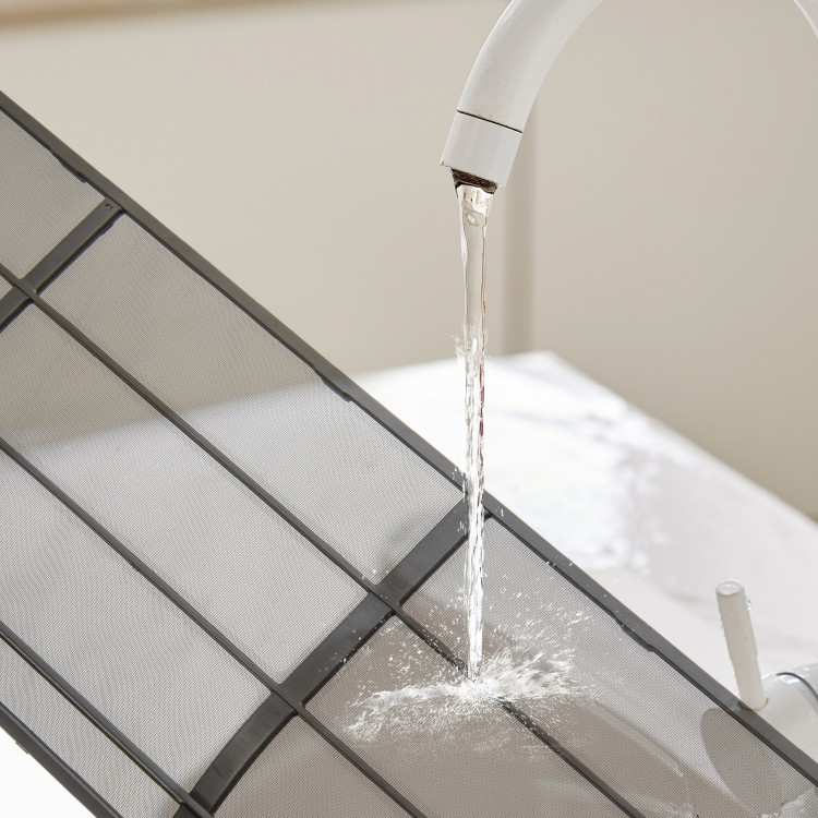 Close-up of the GreyVolt Mini Split Air Conditioner showing water flow, highlighting its self-cleaning feature for easy.