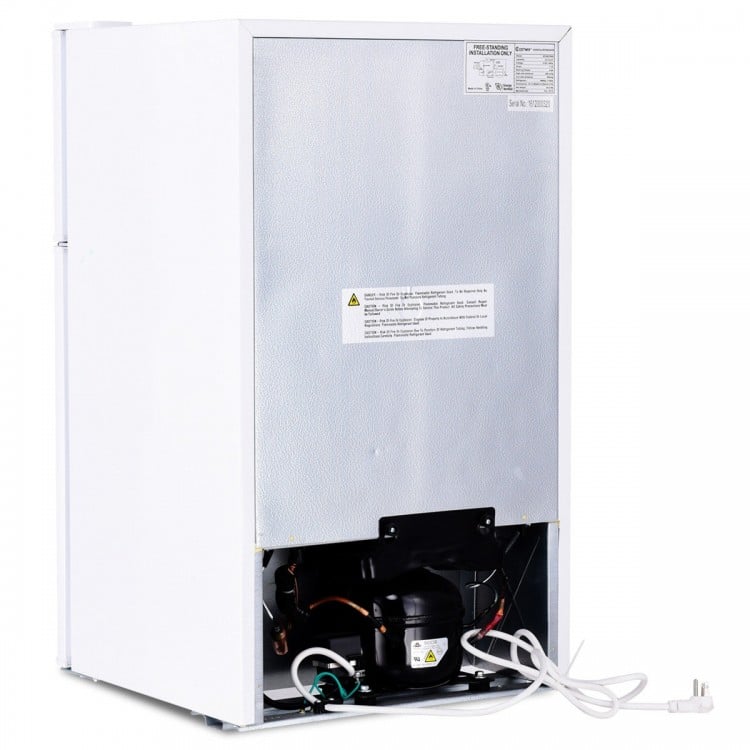 Compact stainless steel refrigerator with adjustable shelves, crisper drawer, and separate freezer compartment for.