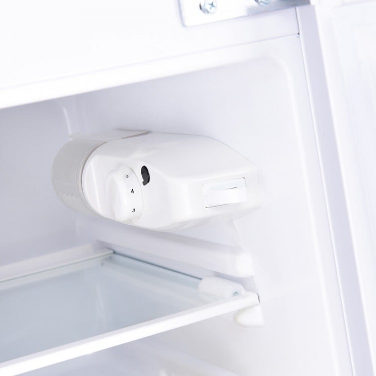 Close-up of the adjustable temperature control in the 3.2 cu ft. compact stainless steel refrigerator. Ideal for food.
