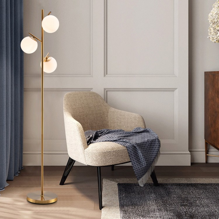 Three-globe floor lamp with a golden finish, featuring a sturdy base and foot switch, perfect for stylish home decor.
