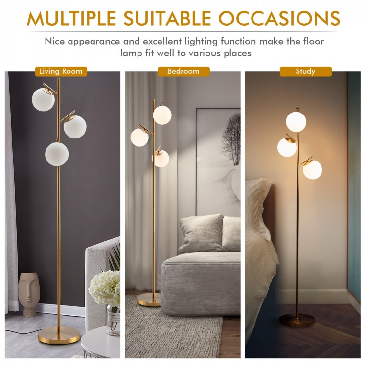 Three-globe floor lamp in gold with glass shades and foot switch, perfect for living room, bedroom, or study use.