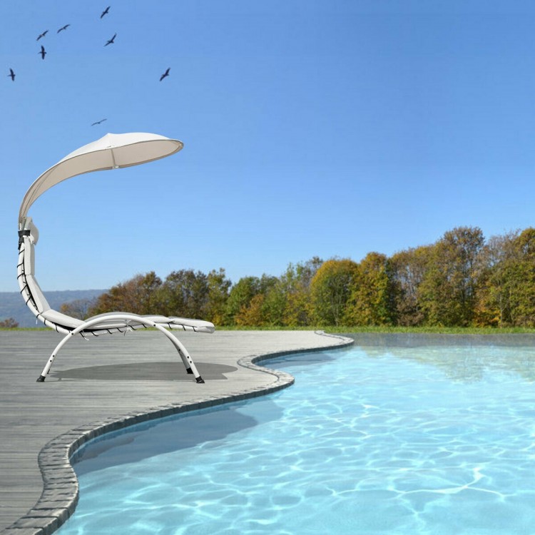Patio hanging swing hammock chaise lounger chair with beige canopy, perfect for poolside relaxation and sun protection.