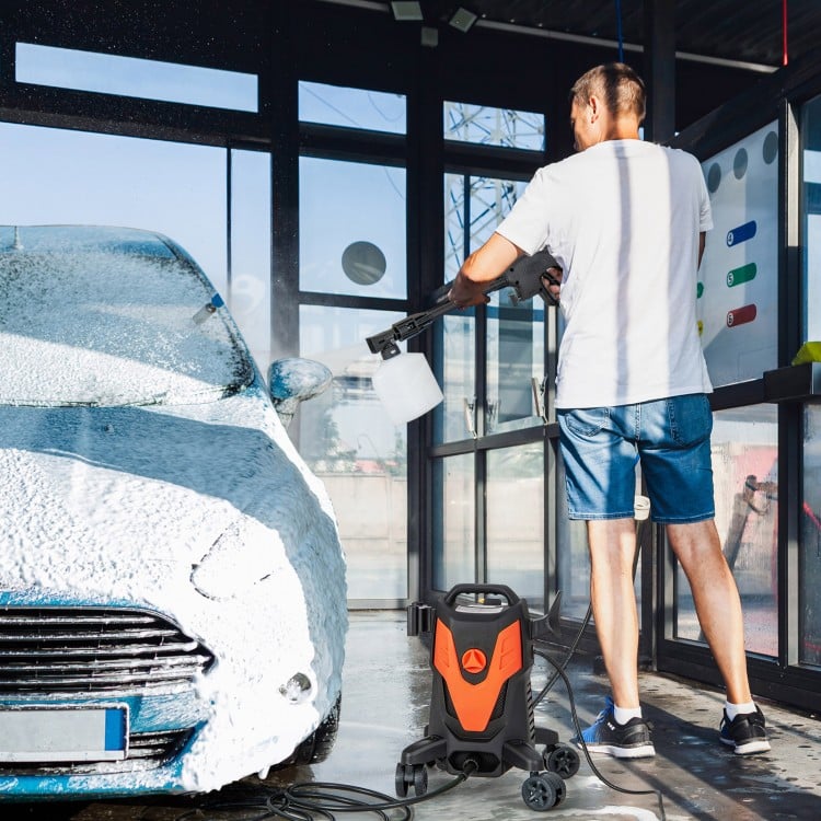 Electric pressure washer with 4 universal wheels in use, cleaning a car with foam, ideal for versatile cleaning tasks.