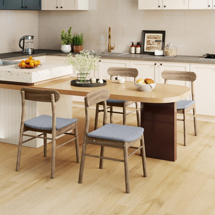 Set of four oak dining chairs with fabric upholstery, rubber wood frame, and curved backrest for lumbar support.