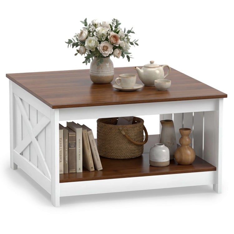 Square farmhouse coffee table with a white finish, featuring a storage shelf and decorative items on top.