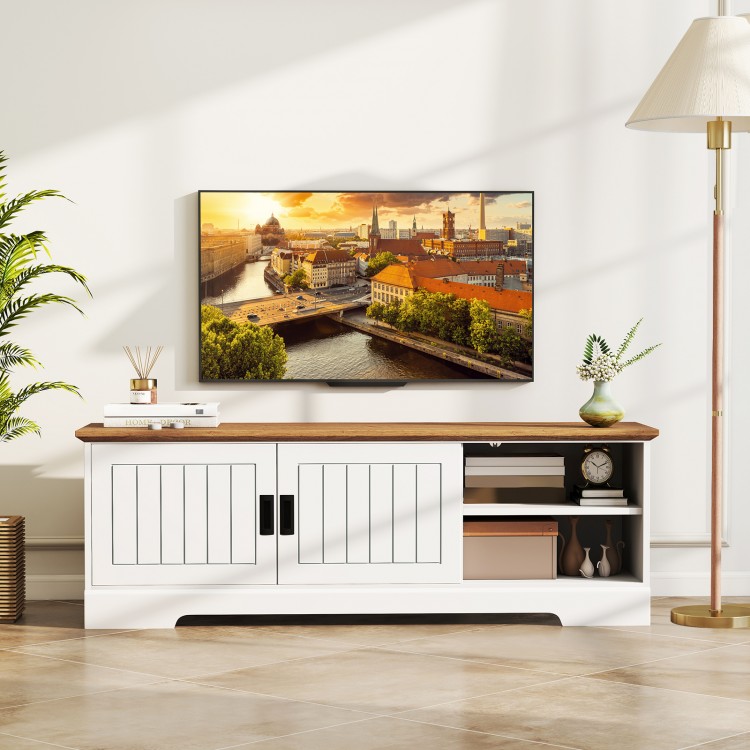 Farmhouse TV stand in white with sliding doors, designed for TVs up to 65 inches, featuring storage cabinets and.