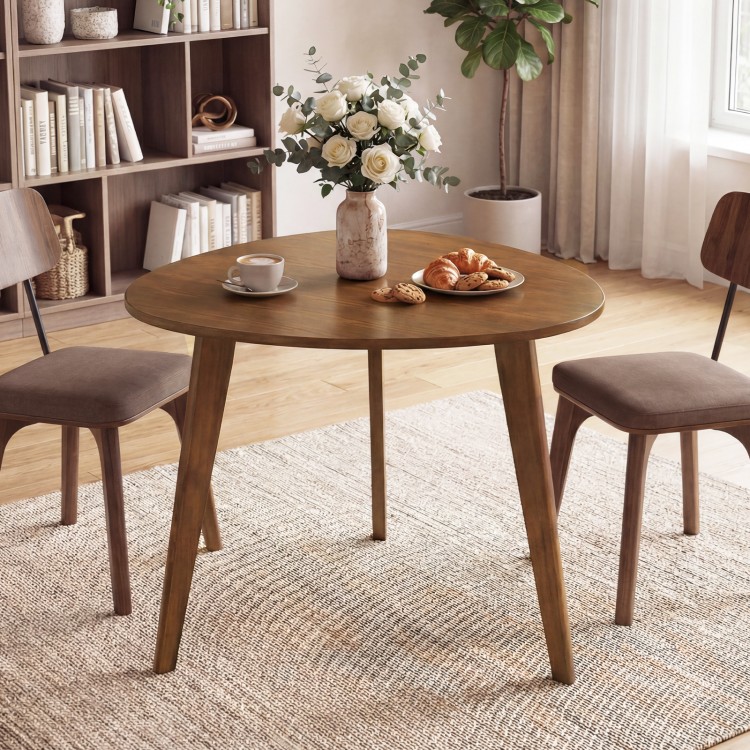 Round walnut dining table for 4 with rubber wood legs, perfect for cozy gatherings in small spaces.