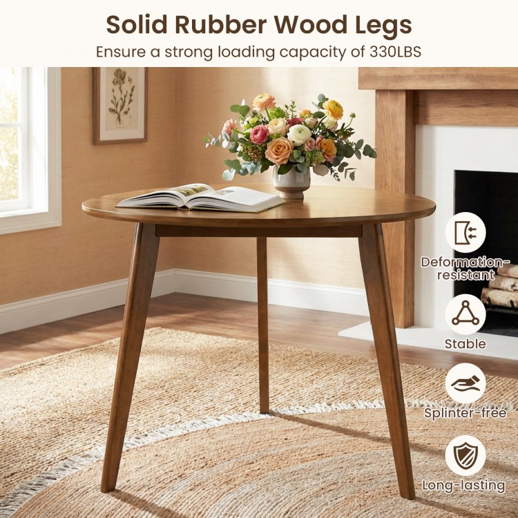 Round walnut dining table for 4 with solid rubber wood legs, offering stability and a smooth, splinter-free surface.