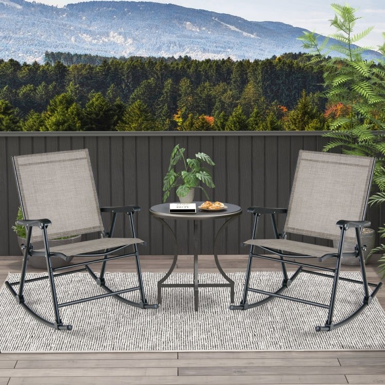 Set of 2 folding rocking chairs with breathable brown fabric, placed on a patio for comfortable outdoor relaxation.
