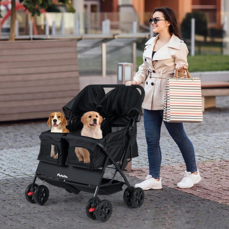 Foldable double pet stroller in black with adjustable sunshade, featuring two pets and a storage basket for convenience.