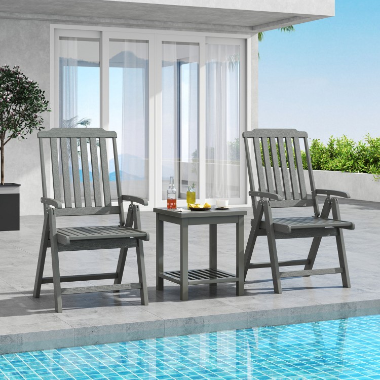 Gray foldable patio chairs with armrests and a side table, perfect for outdoor dining and relaxation by the pool.