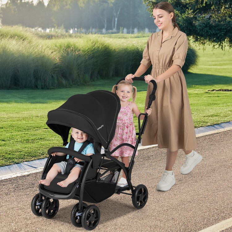 Foldable twin tandem stroller in black with adjustable handlebar, featuring sit and stand options for kids.
