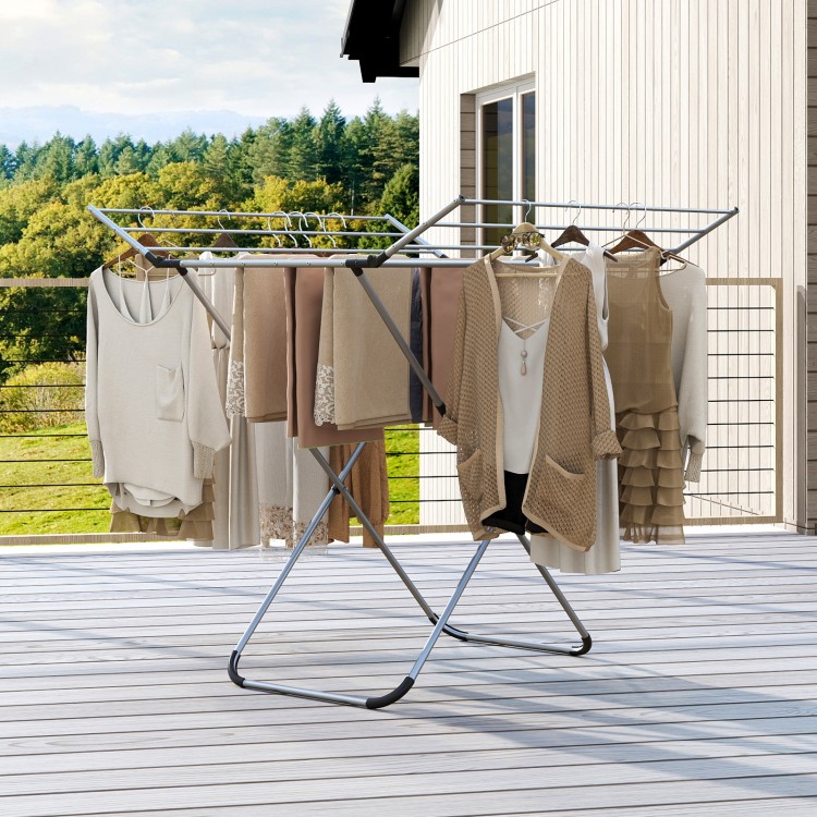 Folding aluminum clothes drying rack with 2 side wings, shown full view with clothes hanging, perfect for outdoor.