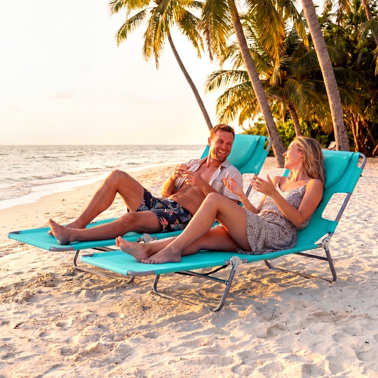 Folding beach lounge chair in light green with adjustable backrest, perfect for relaxing by the ocean or poolside.
