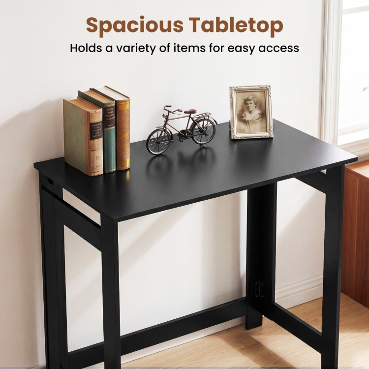 Folding console table in black with spacious tabletop, ideal for hallway or living room, showcasing books and decor.