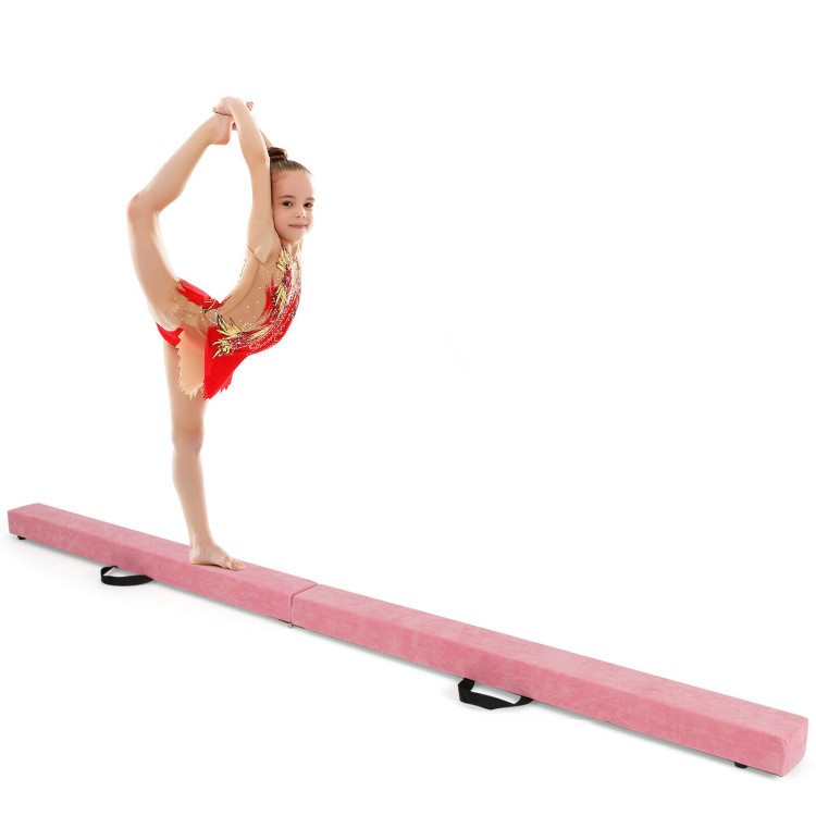 Young gymnast performing on a pink portable balance beam, featuring a sturdy pine wood core and soft suede surface.