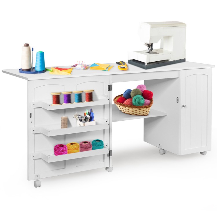 Folding sewing table in white with storage shelves, three bins, and wheels for easy mobility and organization.