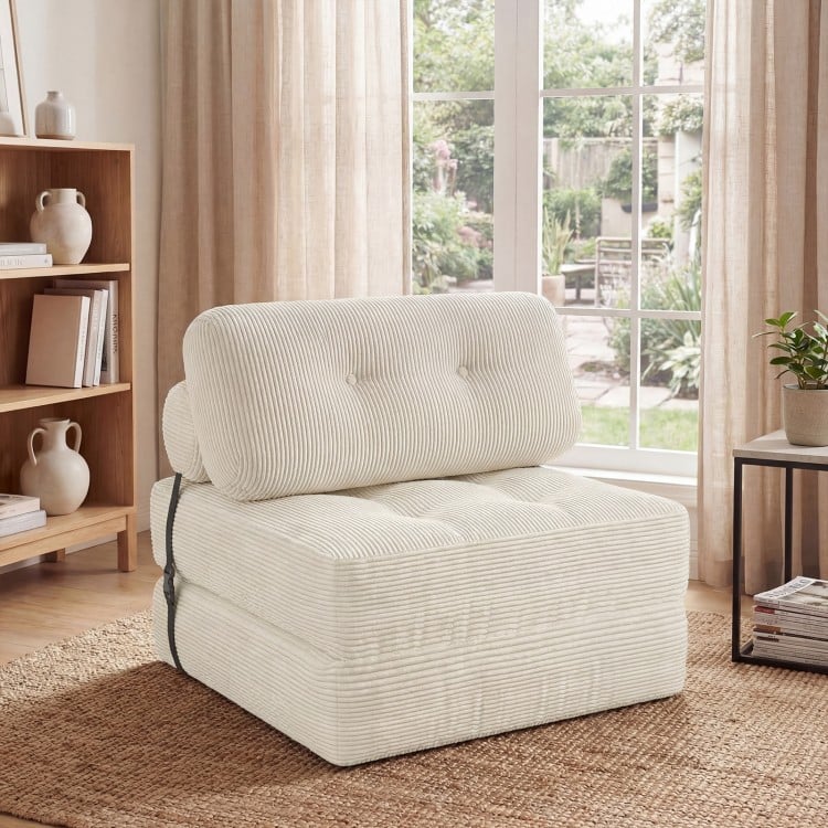 Folding sofa bed in beige with back support and pillow, featuring soft corduroy for comfort in living rooms or guest.