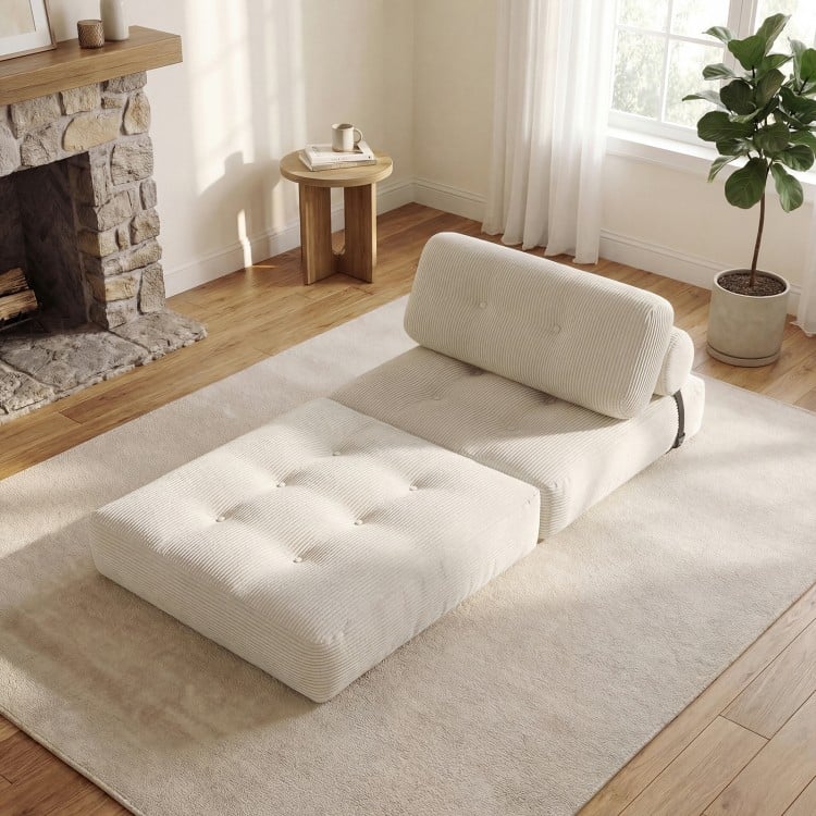 Folding sofa bed in beige with back support, featuring a corduroy cover and button design, ideal for living rooms.