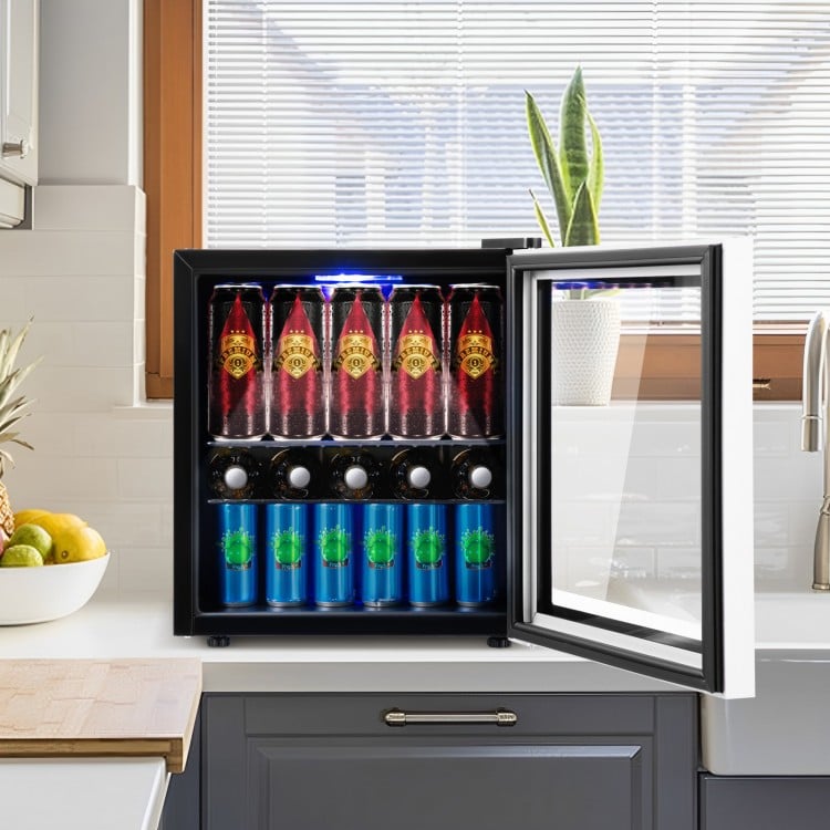 Mini refrigerator with glass door, holding 60 cans, featuring LED light and adjustable shelves for easy beverage access.