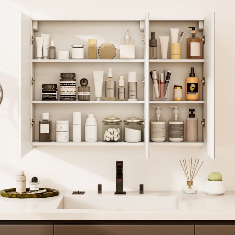 Frameless bathroom wall-mounted mirror cabinet with three mirrored doors and ample storage for cosmetics and toiletries.