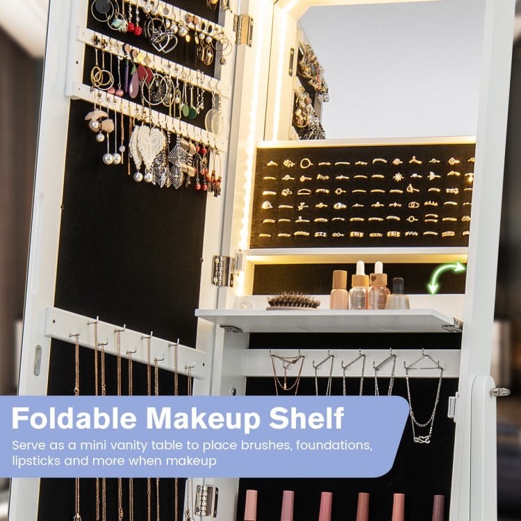 Foldable makeup shelf in a white jewelry armoire, featuring LED lights and storage for cosmetics and accessories.