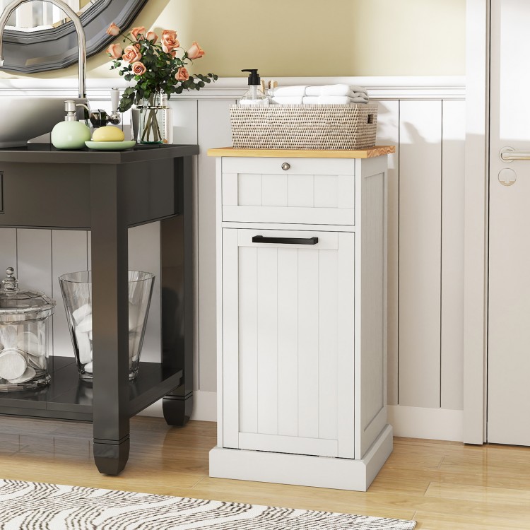 Freestanding tilt-out laundry cabinet in white with bamboo top, featuring a removable hamper and metal drawer knob.