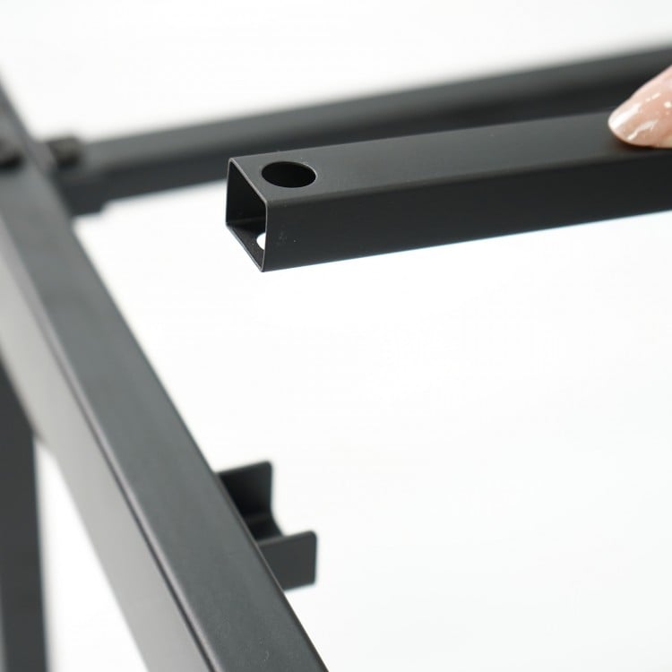 Detail of the heavy-duty metal bed frame showing the powder-coated slats and snap-on connection for stability.
