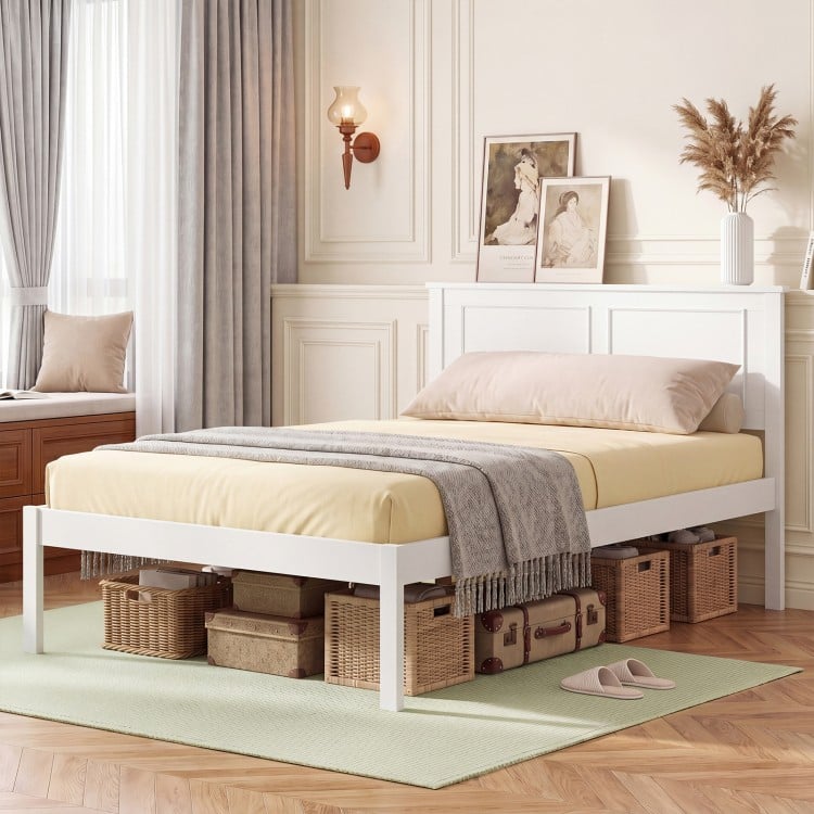 Twin size farmhouse wooden platform bed frame in white with headboard, featuring under-bed storage for boxes and bins.