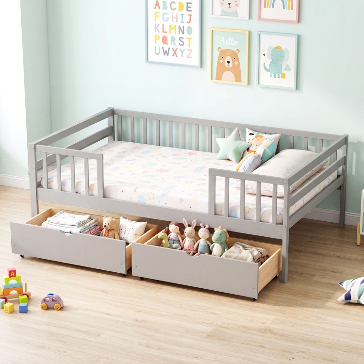 Full size gray daybed with fence and two pull-out drawers, perfect for children's storage and safety.