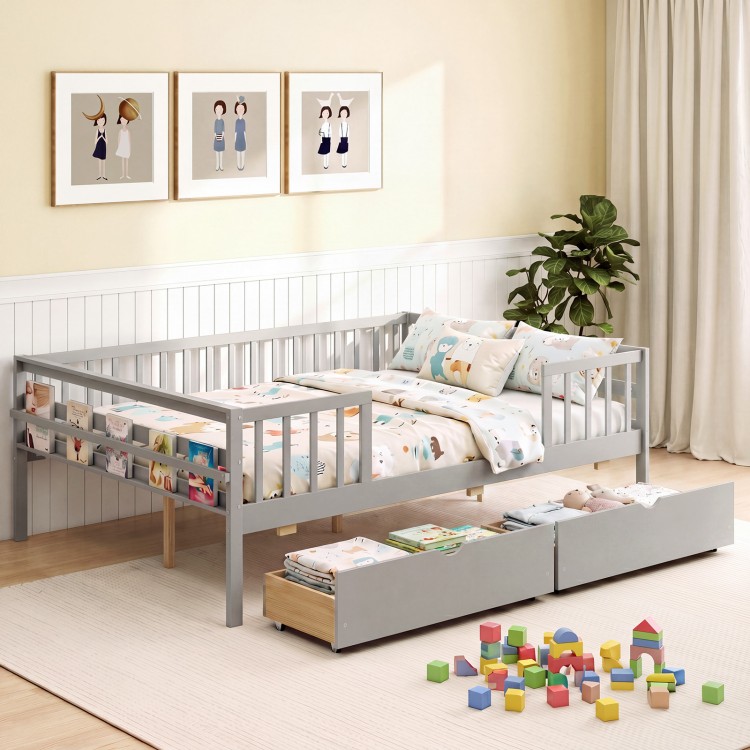 Full size gray daybed with fence and two pull-out drawers, perfect for children's storage and safety in a cozy room.